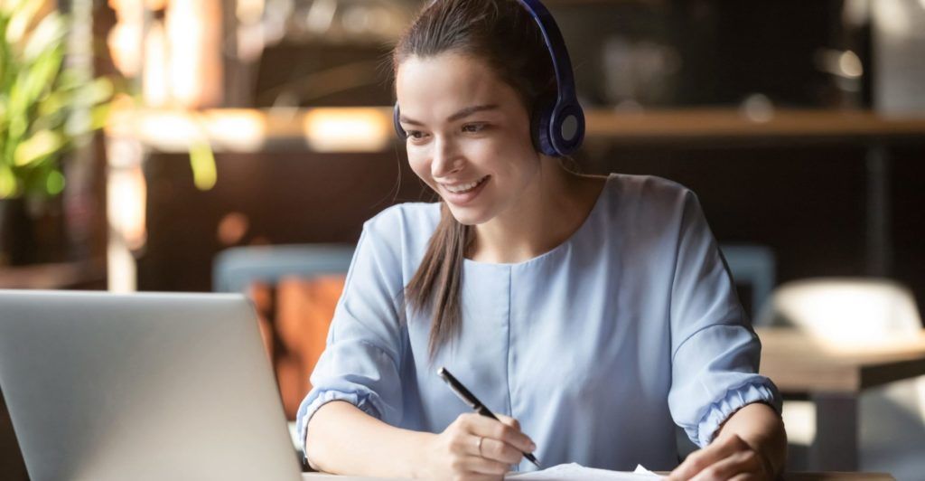 Student with her headphones staring at her laptop during an EPIC PREP online course lesson