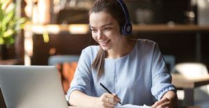 Student with her headphones staring at her laptop during an EPIC PREP online course lesson