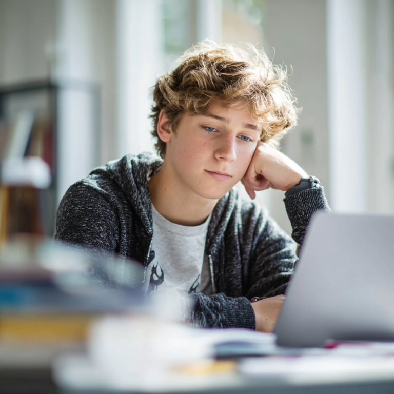 Student reviewing SAT practice questions on the SAT Bluebook App, using his laptop to simulate the real digital SAT environment and improve performance.
